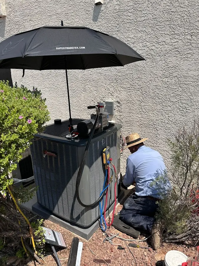 HVAC technician performing outdoor AC maintenance in Montville