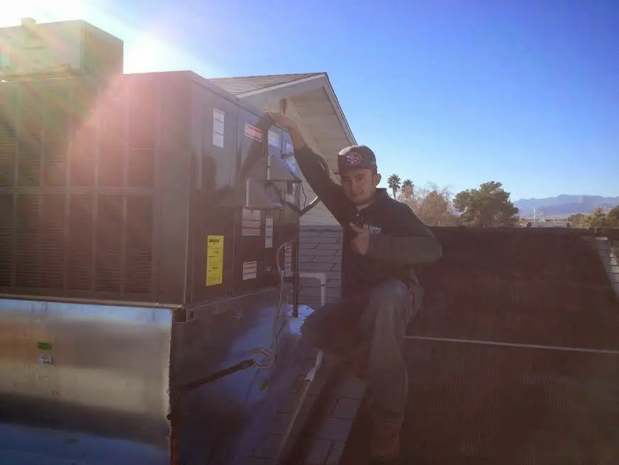 HVAC technician performing Heat Pump Repair on a rooftop unit in Montville
